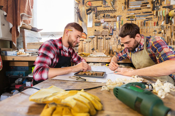 carpenters with tablet and blueprint at workshop - Foto, Imagen