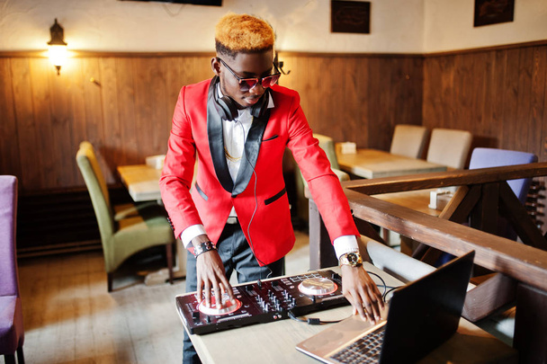 Fashion african american man model DJ at red suit with dj controller.  - Photo, Image