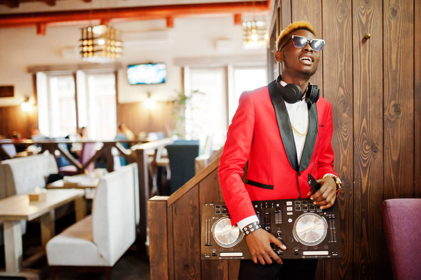 Fashion african american man model DJ at red suit with dj controller.  - Photo, image