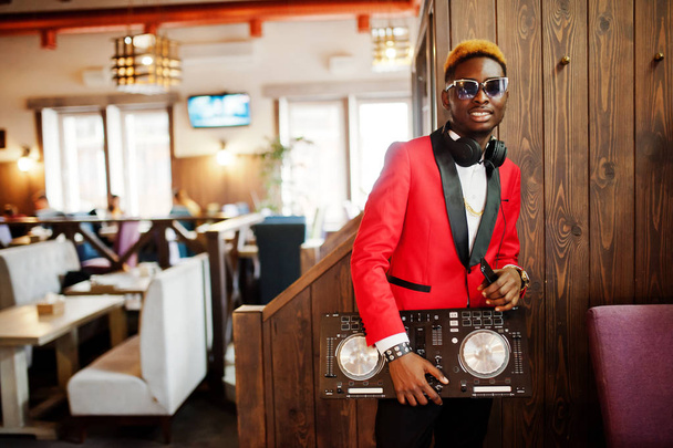 Fashion african american man model DJ at red suit with dj controller.  - Foto, afbeelding