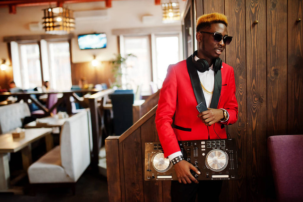 Fashion african american man model DJ at red suit with dj controller.  - Фото, зображення