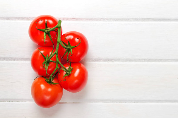 Tomato branch on white wooden background. Close up. Selective focus. - Valokuva, kuva
