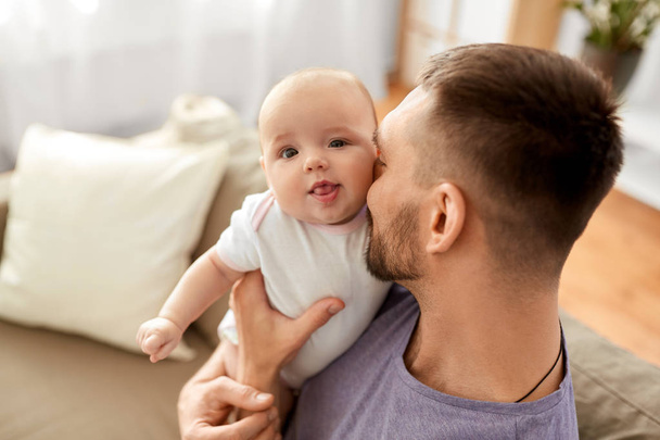 close up of father with little baby girl at home - Foto, imagen