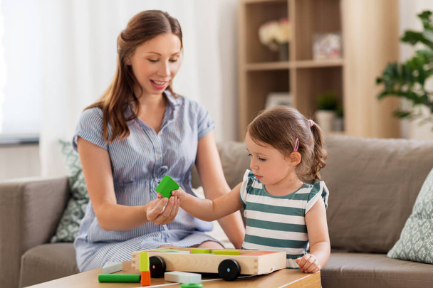 pregnant mother and daughter with toy blocks - Photo, image