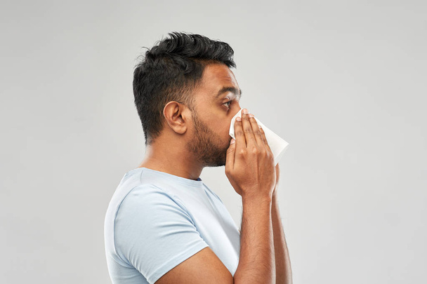 indian man with paper napkin blowing nose - Fotoğraf, Görsel