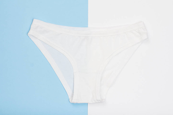 Beautiful cotton panties on blue and white background. Woman underwear set. Romantic lingerie. - Photo, Image