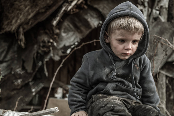sad homeless boy in abandoned village - 写真・画像