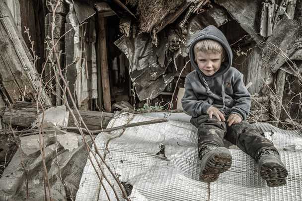 sad homeless boy in abandoned village - Foto, Imagen