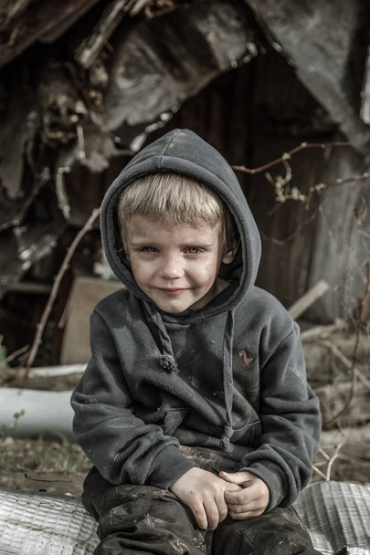 sad homeless boy in abandoned village - Foto, Bild