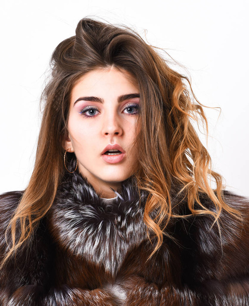 Girl fur coat posing with hairstyle on white background close up. Prevent winter hair damage. Woman makeup calm face hair volume hairstyle. Winter hair care tips you should follow. Hair care concept - Fotografie, Obrázek