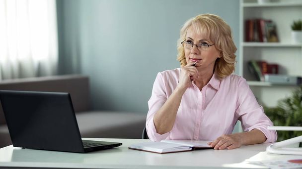 Elegant blond lady in eyeglasses planning day, female freelancer working home - Photo, Image