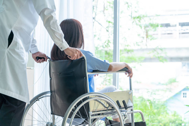Asian female patient on wheelchair with senior doctor - Zdjęcie, obraz