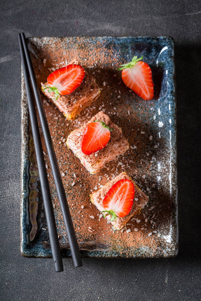 Fresh sweet sushi with cinnamon and chocolate on concrete table - Valokuva, kuva