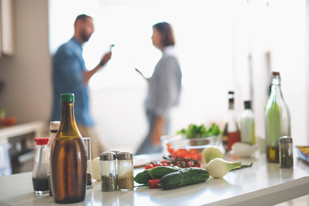 Ingredients for cooking and couple on blurred background - Valokuva, kuva