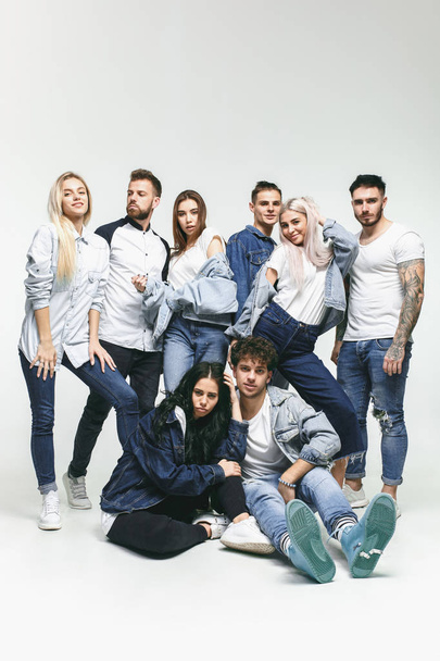 Group of smiling friends in fashionable jeans - Φωτογραφία, εικόνα