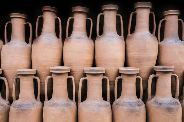 Ancient roman amphorae stored at hold ship as ancient times trade. Isolated over black - Foto, Bild