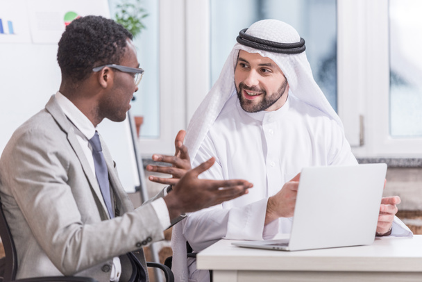 Multiethnic businessmen having discussion in modern office  - Фото, изображение