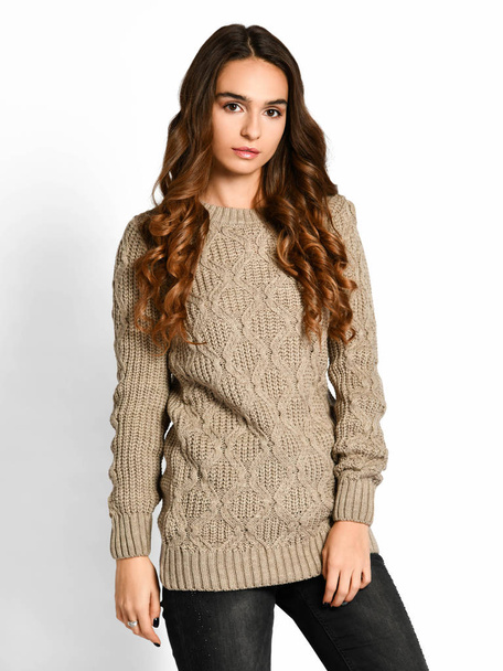 Young beautiful brunette curly woman posing in new casual grey blouse sweater  - Zdjęcie, obraz