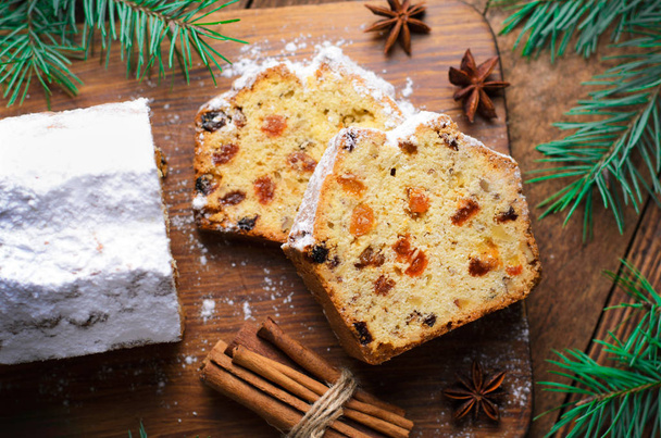 Fruit Loaf Cake Dusted with Icing Sugar, Christmas and Winter Holidays Treat, Homemade Cake with Raisins on Wooden Background - Foto, immagini