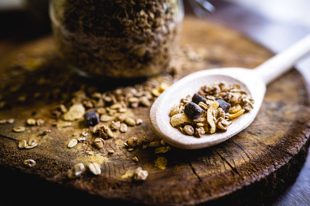 image of an old wooden spoon with oats, cereal and seeds. Ingredients for a healthy lifestyle. - Foto, Imagen