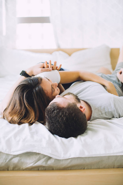 Woman and man lying in bed , happy young couple - Foto, Imagem