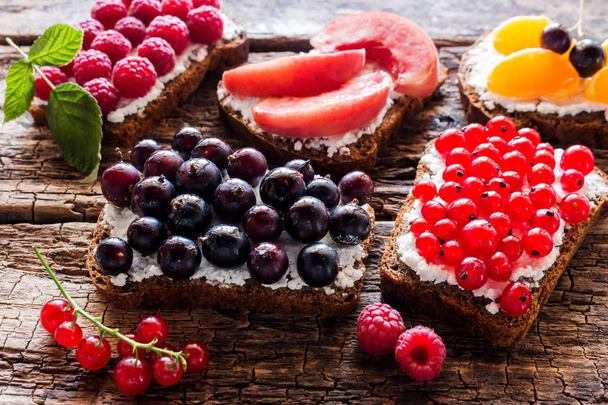 homemade sandwiches with wild berries and fruit closeup - Фото, изображение