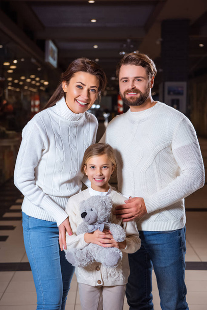 portrait of happy parents and daughter with teddy bear looking at camera - Φωτογραφία, εικόνα