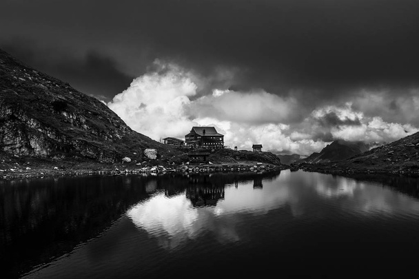 Beautiful landscape with Wildsee Lake ( Wildseelodersee ) and  the Wildseeloderhaus, mountain refuge hut, above Fieberbrunn in the Kitzbuhel Alps, Tirol, Austria. Creative black and white image. - Photo, Image