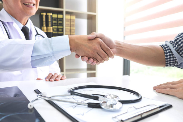 Professor Doctor having shaking hands with patient after recommend treatment method while discussing explaining his symptoms or counsel diagnosis health, healthcare and assistance concept. - Photo, Image