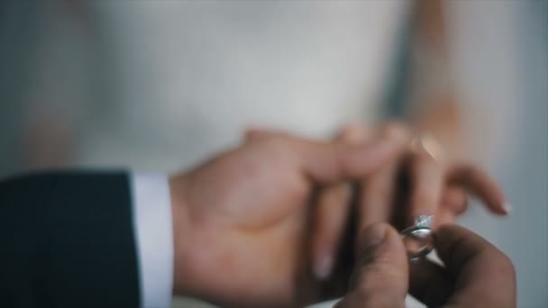 The groom puts the wedding ring on finger of the bride. marriage hands with rings. The bride and groom exchange wedding rings. - Footage, Video