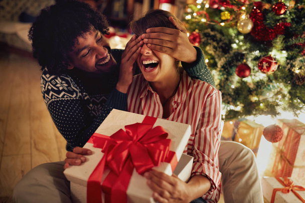 Christmas surprise - couple opening presents - Photo, image