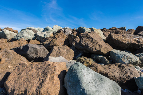 Huge stone formation on a hilltop. Big stones and rocks in different colors - Photo, Image