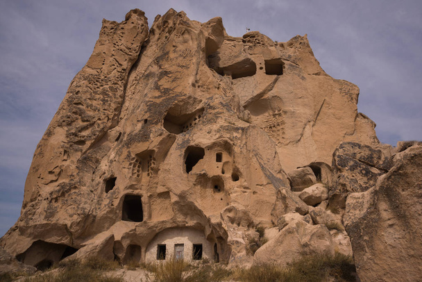 Uchisar, Cappadocia, Anatolia: The fortress Urchisar Castle in Cappadocia located on the highest point in the region. Houses are built into the hillside. - Photo, image