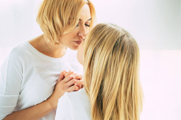 Happy mother and daughter together at home - Photo, image