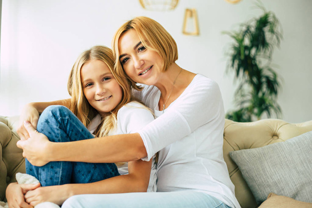 Happy mother and daughter together at home - Φωτογραφία, εικόνα