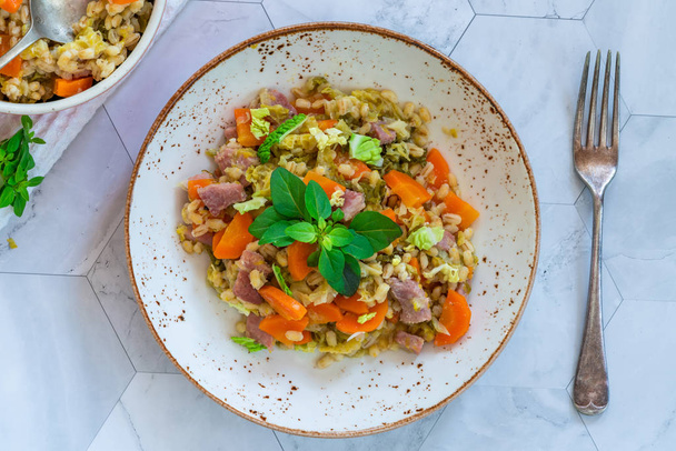 Pearl barley and bacon cassarole with carrots, leek and savoy cabbage - top view - Photo, Image