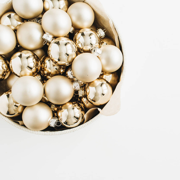 Christmas golden decoration balls on white background. Flat lay, top view. Minimal composition. - Foto, Imagem
