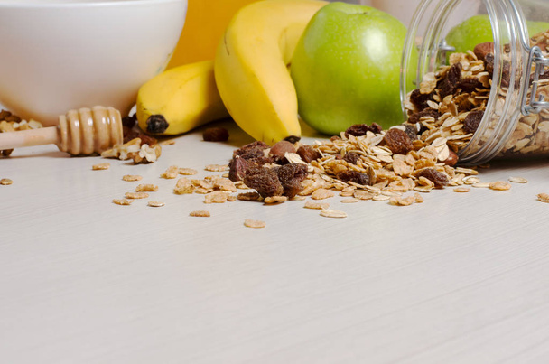 Healthy Breakfast. Granola, apples, bananas, nuts on a white table. Close up - Foto, Imagen