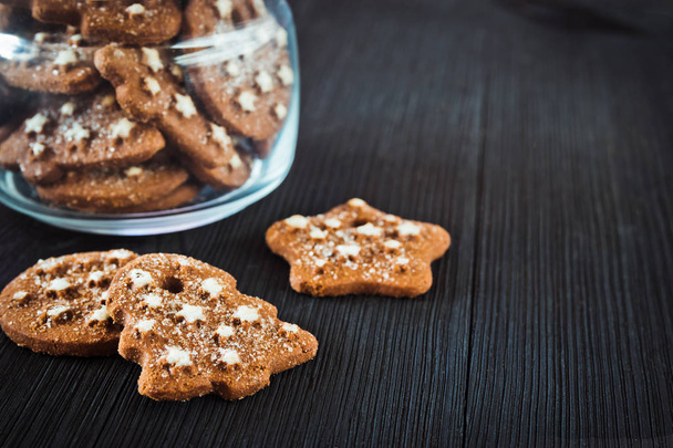 Christmas cookies on a black wooden background - Fotoğraf, Görsel