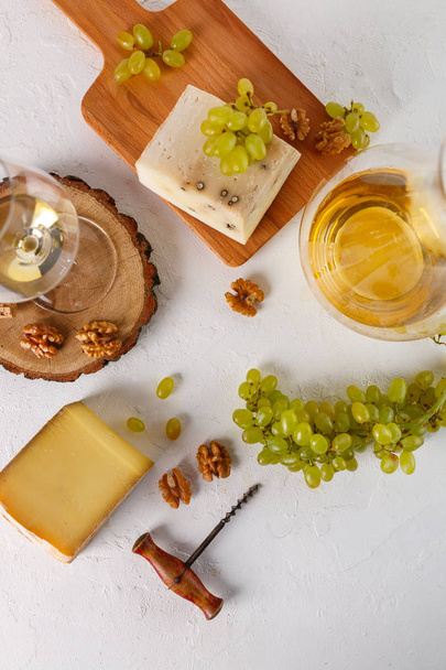 wine, grapes, cheese and nuts on white background. Top view. Flatlay - Photo, Image