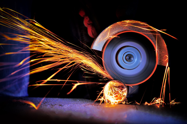 Worker cutting metal with grinder - Photo, Image