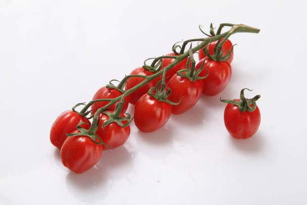 Vegetables, tomatoes on a branch on a white background. - Photo, image