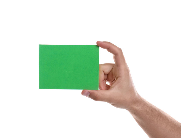 Football referee holding green card on white background, closeup - Фото, изображение