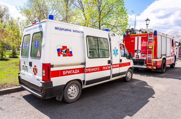 Samara, Russia - 9 maggio 2018: Ambulanza auto e camion dei pompieri parcheggiati in strada. Testo sul russo: "Team di risposta alle emergenze
" - Foto, immagini
