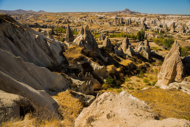 Cappadocia, Turkey: Beautiful landscape on the panorama of mountains and rocks. The fortress of Uchisar on the horizon. Love Valley, Gorkundere. - Photo, Image