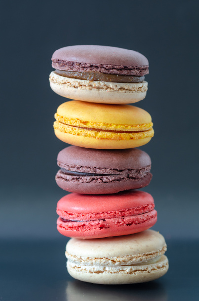 Colorful macaroons are on the dark background, - Photo, Image