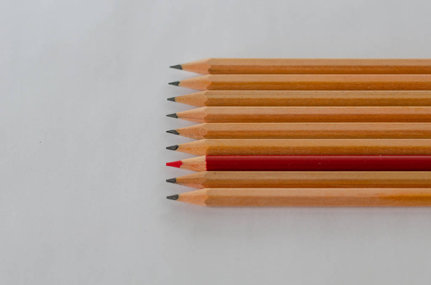 Red pencil and black pencils on white background. think different, business success concept - Photo, Image