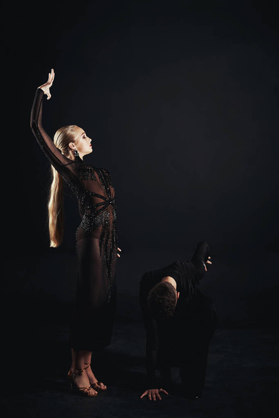 Beauty, fashion. Dancing over black background, beautiful couple of ballet dancers - Photo, image
