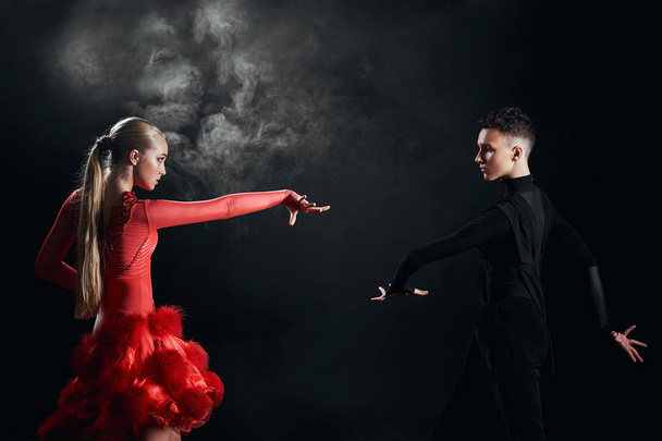 Beauty, fashion. Dancing over black background, beautiful couple of ballet dancers - Photo, image
