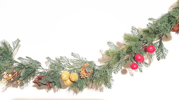 Green Merry Christmas Garland With Nature Ornaments.  Happy Holidays and Season's Greetings Greenery Decoration. - Fotó, kép